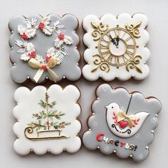 four decorated cookies with different designs on them, one for christmas and the other for new year's eve