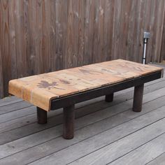 a bench sitting on top of a wooden deck