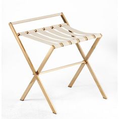 a wooden folding chair sitting on top of a white floor