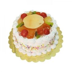 a white cake with fruit toppings on top