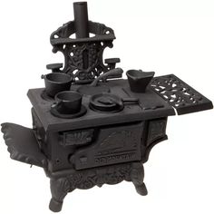 an antique cast iron stove with pots and pans on it's burners