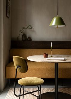 a table with two chairs and a lamp above it