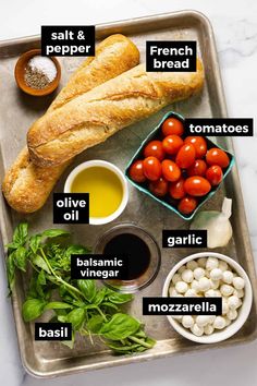 bread, tomatoes, garlic and other ingredients on a tray