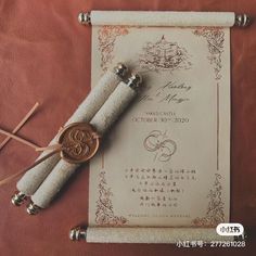 an old scroll with some writing on it next to two small metal scissors and a paper clip