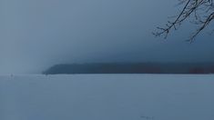 a person walking across a snow covered field