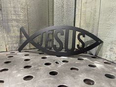 a metal fish with the word jesus on it