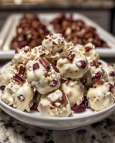 a white plate topped with lots of desserts on top of a marble countertop