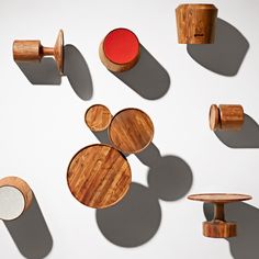 several wooden objects are arranged on a white surface