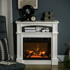 a living room with a fire place in the center and pictures on the wall above it