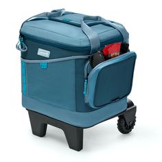 a large blue bag with wheels on it's side and some items in the back