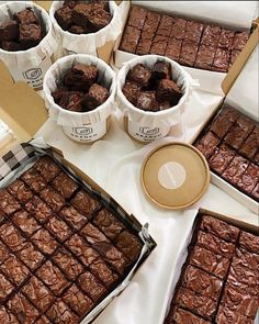 chocolate brownies and cups of ice cream on a table