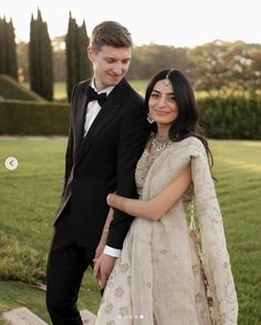 a young man and woman dressed in formal wear