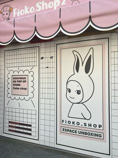 a store front with posters on the side of it's windows and an advertisement for fiko - shop 2