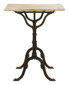 an iron and marble table on stand with two legs, the top is turned upside down