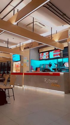 the inside of a fast food restaurant with tables and chairs