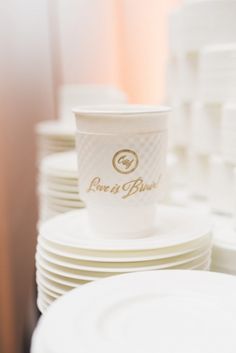 a stack of white plates and cups with the words love is pure written on them