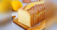 a loaf of lemon pound cake sitting on top of a cutting board