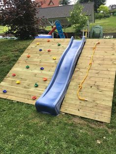 a blue slide sitting on top of a wooden deck