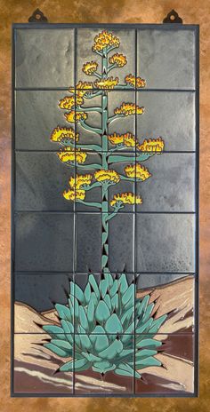 a tile wall with a painting of a plant on it's side and yellow flowers in the middle