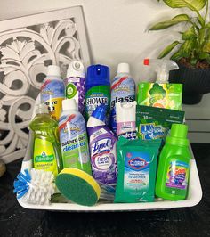 a white tray filled with lots of different types of cleaning products on top of a table