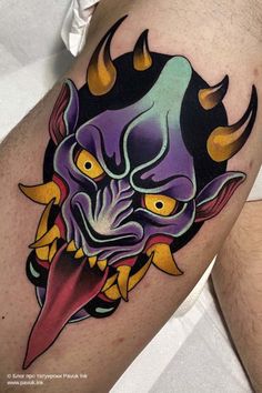 a man's thigh with a demon tattoo on it