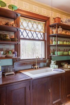 the kitchen is clean and ready to be used for cooking or baking, as well as dishes on shelves