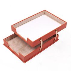 an orange box with two open compartments on the bottom and one closed drawer at the top