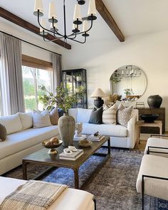 a living room filled with furniture and a large mirror