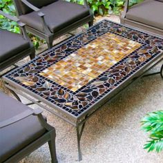 an outdoor table with chairs around it and a mosaic tile top on the outside patio