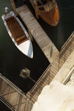 two boats docked at a pier in the water