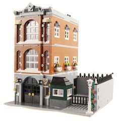 a large building made out of legos on a white background with the front door open