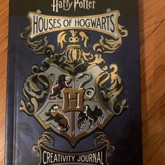 harry potter houses of hogwarts activity book on a wooden table with wood flooring