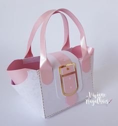 a small pink and white bag with a gold buckle on it's front pocket