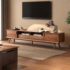 a living room with a large television mounted on the wall and wooden furniture in front of it