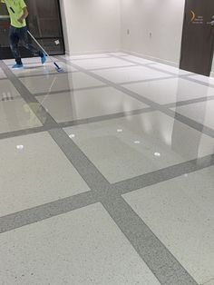 a man is cleaning the floor with a mop in an office building or conference room