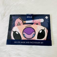 a pink and black piggy makeup set in a box on a white fur surface