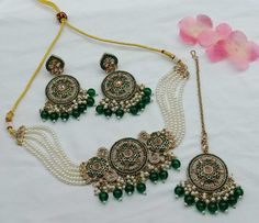 Description: Enhance your elegance with this stunning Traditional Indian Kundan Necklace Set featuring matching earrings, meticulously crafted to perfection. This exquisite jewelry set is the epitome of luxury, blending traditional design with contemporary flair, making it a must-have for every jewelry collection. Product Features: Material: High-quality Kundan stones, gold-plated alloy, and pearl detailing. Design: Intricately designed with a beautiful combination of green and pink beads that add a pop of color, perfect for any occasion. Earrings: Matching earrings with a comfortable fit, complementing the necklace perfectly. Necklace Length: Adjustable with a drawstring closure to suit your neckline and preference. Occasion: Ideal for weddings, bridal wear, engagements, festive occasions Kundan Choker Necklace, Earrings Matching, Kundan Necklace Set, Kundan Choker, Kundan Necklace, Bollywood Jewelry, Pearl Bridal, Kundan Necklaces, Indian Bollywood