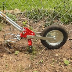 there is a wheel attached to the side of a fence with a plow on it