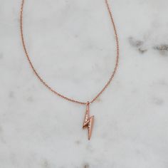 Super cute lightning bolt charm necklace featuring a pave detail. Looks great on its own or paired with other necklaces! Made of 925 Sterling Silver We use a THICK plating of Rhodium or Rose Gold - for a piece that will be with you for years to come! 16" + 3" Ext Chain Bolt Charm: 20mm x 5mm Lobster Clasp Closure Nickel-free & Hypoallergenic Cute Lightning Bolt, Lightning Necklace, Lightning Bolt Necklace, Dainty Gold Necklace, Pure Love, Necklace Dainty, Lightning Bolt, Rose Gold Necklace, Delicate Necklace