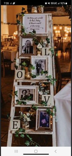 an old ladder is decorated with photos and greenery for a wedding reception or special occasion