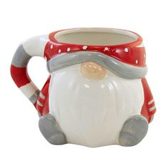 a ceramic santa clause mug with red and white stripes on the bottom, sitting in front of a white background