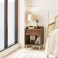 a bed sitting next to a window with a white bedspread on top of it