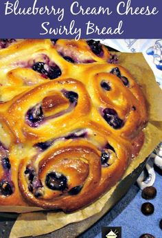 a blueberry cream cheese swirly bread is shown on a table with chocolate candies