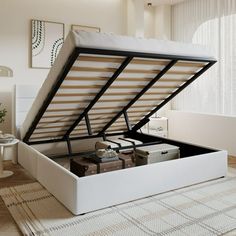 an open white bed frame sitting on top of a rug in a living room next to a window