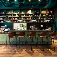 the interior of a restaurant with bar stools