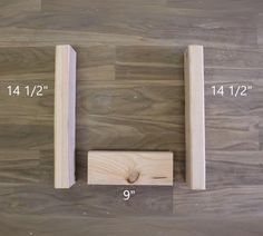 two wooden brackets are on the floor with measurements