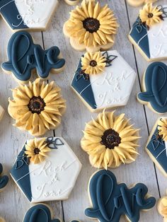 decorated cookies with sunflowers and monogrammed cookie cutters on a table