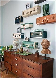 a dresser with many suitcases on the wall