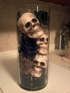 there is a glass with three skulls in it