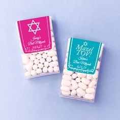 two small bags of white chocolate candies on a blue surface with a star of david in the background